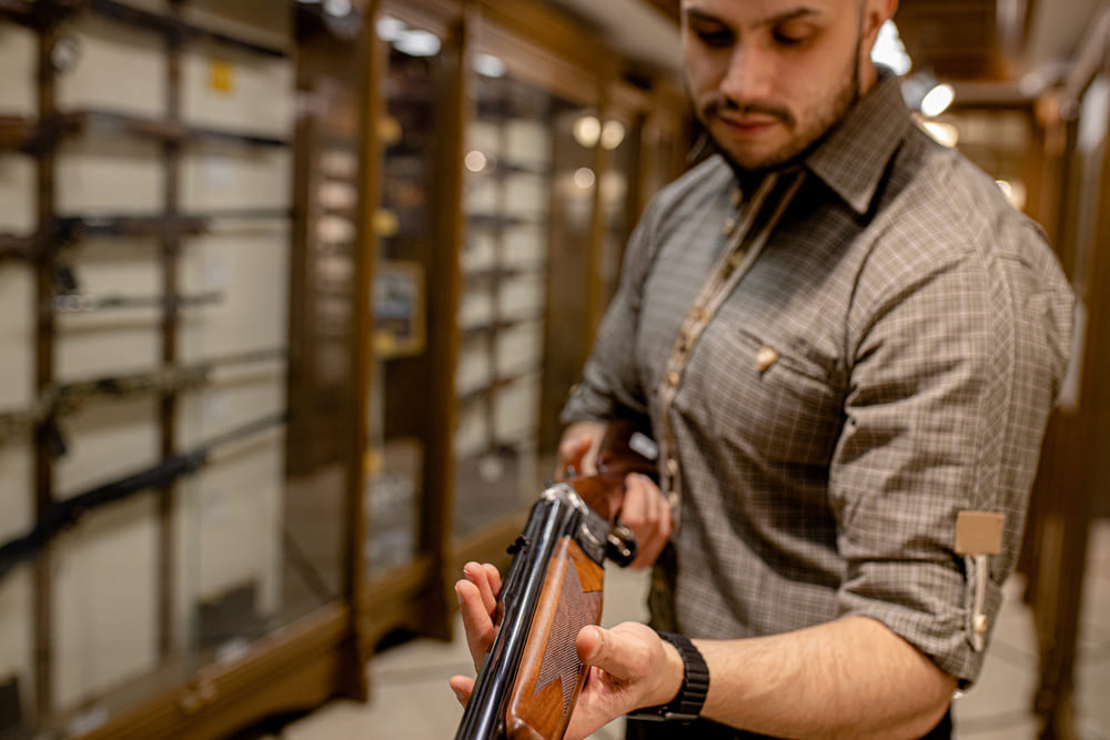 hunter buying a rifle with silencer